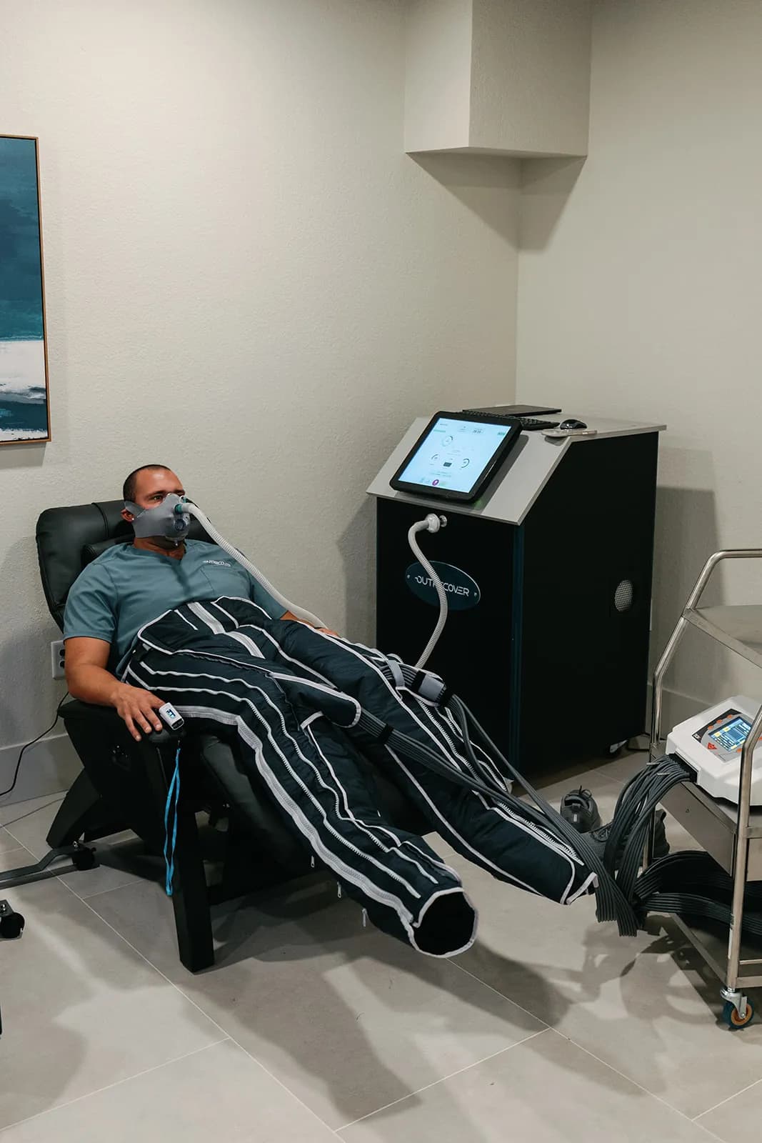 Client in full-leg lymphatic compression garments at OutRecover in Naples, FL